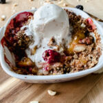 Blackberry Peach Cobbler served with vanilla ice cream.