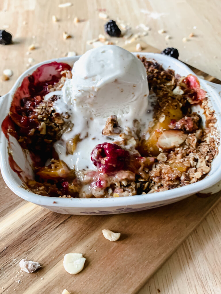 Blackberry Peach Cobbler served with vanilla ice cream.